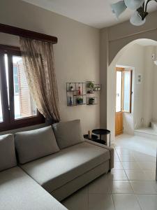a living room with a couch and a window at Lagom House in Panagia