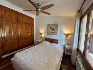 a bedroom with a bed and a ceiling fan at Torre Vella 66 in Torroella de Montgrí
