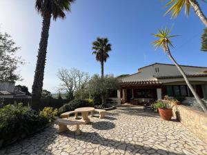 a patio with a picnic table and palm trees at Torre Vella 66 in Torroella de Montgrí