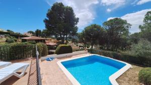 a swimming pool in a yard with a bench next to it at TV 57 privat pool in Torroella de Montgrí