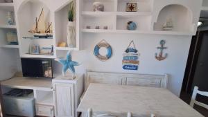 a dining room with a table and shelves at La Font Lovely apartment LEstartit 400 meter from the beach in L'Estartit