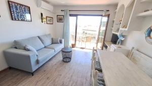 a living room with a couch and a table at La Font Lovely apartment LEstartit 400 meter from the beach in L'Estartit