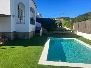 a villa with a swimming pool in front of a house at Alemanya 38 in Torroella de Montgrí