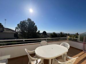 a white table and chairs on a balcony at Casa Buckingham 27C in Torroella de Montgrí