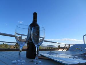 two wine glasses sitting on a table with a bottle of wine at Casa Buckingham 27C in Torroella de Montgrí +19 photos