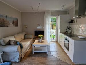 a living room with a couch and a table at FeWo Gisa - Graal Müritz in Graal-Müritz