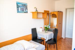a small dining room with a table and chairs at Helena in Karwia +26 photos