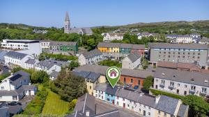 an aerial view of a city with buildings and a green sign at The Old Forge Clifden in Clifden