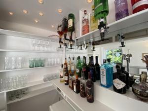 a bar with bottles of alcohol on shelves at Old Farm Hotel in Birmingham