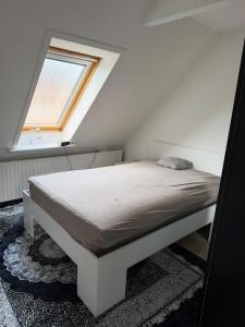 a bed in a room with a window at Quiet Apartment in Horsens in Horsens