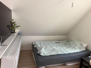 a bed sitting in a room with a counter at Quiet Apartment in Horsens in Horsens