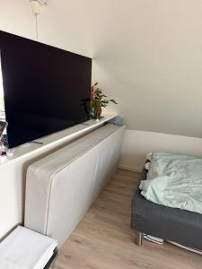 a living room with a flat screen tv on a wall at Quiet Apartment in Horsens in Horsens