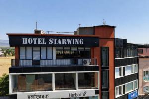 a hotel building with a sign that reads hotel shining at Hotel Starwing in Pāonta Sāhib