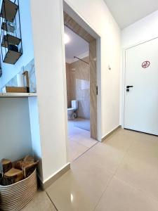 a hallway with a door leading to a bathroom at Central Loft Studio Târgoviște in Târgovişte +25 photos