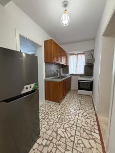 a kitchen with a refrigerator and a sink at Guest House Central Vlora in Vlorë