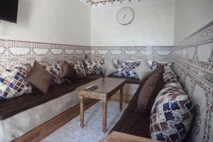 a living room with a couch and a table at Bab Akchour in Chefchaouen