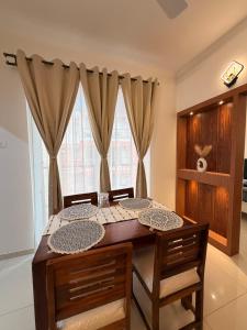 a dining room with a table and chairs and a window at Casa sol Goa 2BR Apt By Amoret Homes in Chicalim