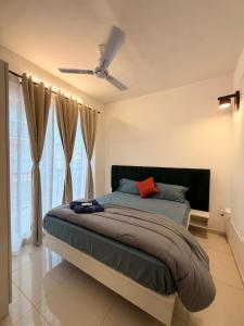 a bedroom with a bed with a red pillow at Casa sol Goa 2BR Apt By Amoret Homes in Chicalim +15 photos