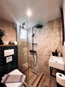 a bathroom with a shower and a sink at Orfeas Luxury Rooms & Studio in Skopelos Town