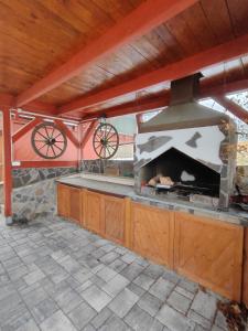 an outdoor kitchen with an outdoor oven with two wheels at Chata Kopánka in Moderštôlňa