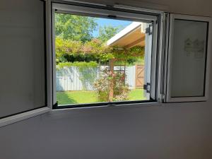 a window in a room with a view of a yard at Little Blue House in Sidari