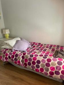 a bed with purple and pink polka dots on it at 7 Main st in Camlough +2 photos