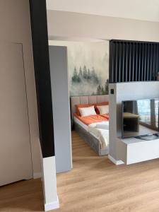 a bedroom with a bed and a fireplace at Piska Przystań in Pisz