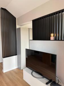 a living room with a large flat screen tv at Piska Przystań in Pisz
