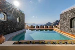 a swimming pool in the middle of a building at Agnadema Apartments in Firostefani