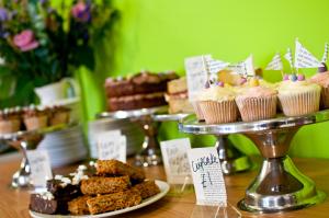a table with a tray of cupcakes and other desserts at YHA South Downs in Lewes