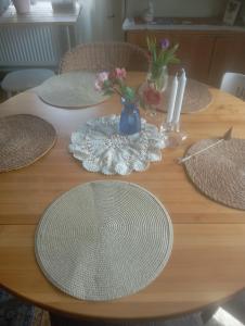 a wooden table with straw hats and flowers on it at Guest Room in Liviöjärvi +4 photos