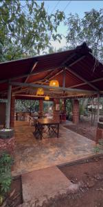 a pavilion with a picnic table under awning at Atithi Parinay Homestay in Ratnagiri