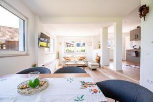 a kitchen and living room with a table and chairs at Häusle Fritz in Weier