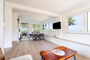 a living room with a table and chairs and windows at Häusle Fritz in Weier