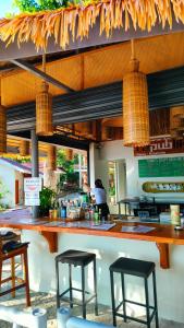 a restaurant with two bar stools and a counter at Republika Beach Resort in San Juan