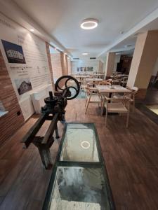 a room with tables and chairs and a camera at Soho Boutique La Harinera in Valladolid