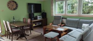 a living room with a couch and a table at Chata Struhadlo in Bezděkov