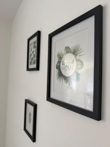 a framed picture of a tropical home on a wall at La Couronne Apartment in La Couronne
