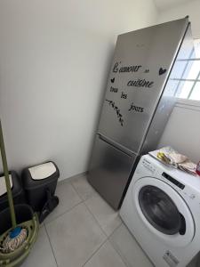 a laundry room with a washing machine and a washer at La Couronne Apartment in La Couronne