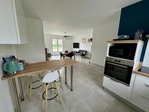 a kitchen with a table and a dining room at La Couronne Apartment in La Couronne