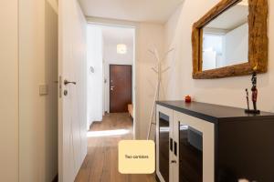 a bathroom with a black desk and a mirror at Charming king appartment with balcony and jacuzzi in Como