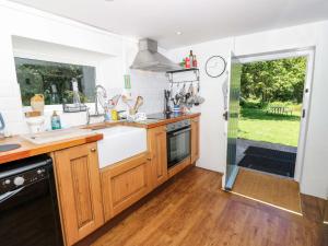 a kitchen with a sink and a stove at Sweet Briars in Chalegreen