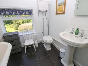 a white bathroom with a sink and a toilet at Sweet Briars in Chalegreen +46 photos