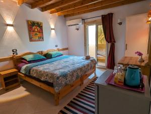 a bedroom with a bed and a table and a window at Dive Urge in Dahab
