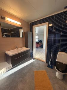 a bathroom with a sink and a bath tub at Varangerfjord Stay in Varangerbotn +6 photos