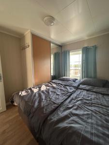 a bedroom with a large bed and a window at Varangerfjord Stay in Varangerbotn