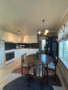a kitchen and dining room with a table and chairs at Varangerfjord Stay in Varangerbotn