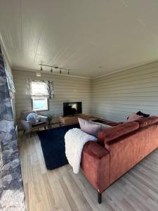 a living room with a couch and a television at Varangerfjord Stay in Varangerbotn