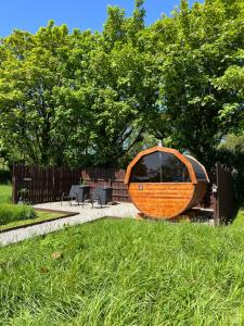 a wooden boat sitting in the grass in a yard at Seaview Retreat - Sauna & Ice Bath in Clonakilty