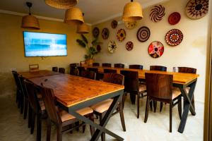 a dining room with a large wooden table and chairs at Wave chaser surfhouse morocco in Agadir